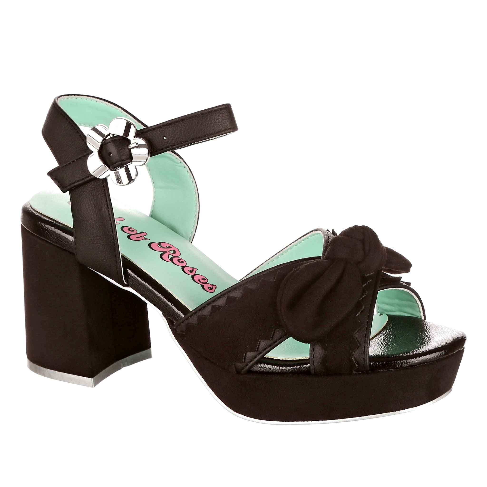 Black strappy open toe sandal with block heel and platform with bow detail on the toe on a white background.
