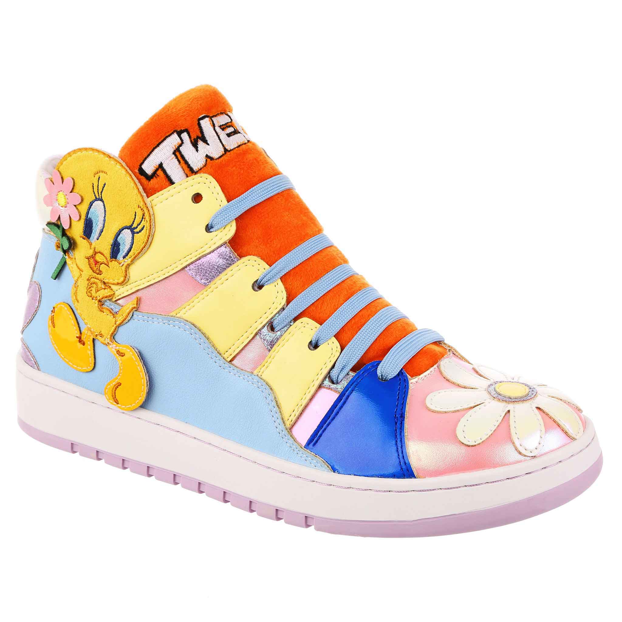 Pastel trainers with iridescent pink fabric and shiny flowers are contrasted with a fluffy orange tongue embroidered with the word Tweety in white. Along a wavy blue panel on the side is an applique of Tweety Bird himself holding a flower.
